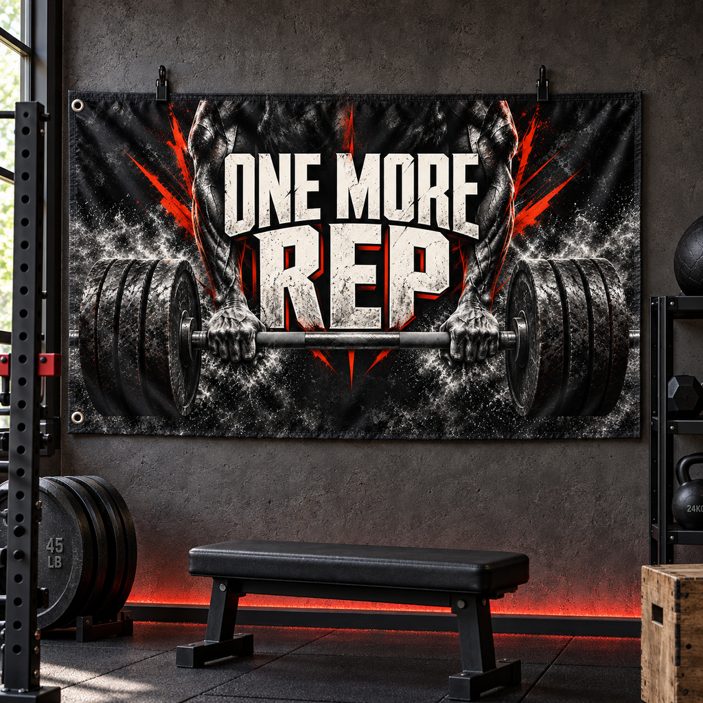 One More Rep Banner in a styled gym; illustrative mockup with two grommets along the left short edge. Display clips and props not included.